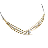 Crafted in 14KT yellow Canadian Certified Gold, this necklace features a round brilliant-cut Canadian diamond between two large diamond-set willow tree leaves.