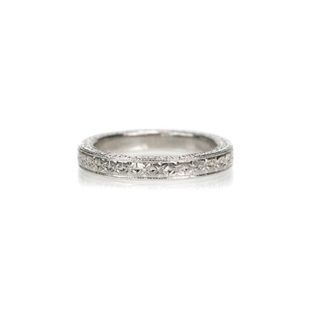 Crafted in 14KT white gold, this band is hand-engraved with an orange blossom design. 