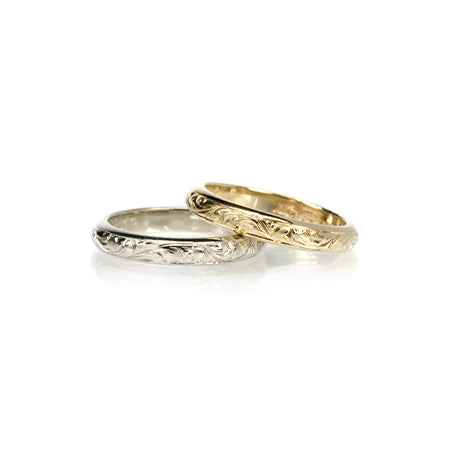 A 14KT yellow gold Round Paisley Band shown with a 14KT white gold Round Paisley Band