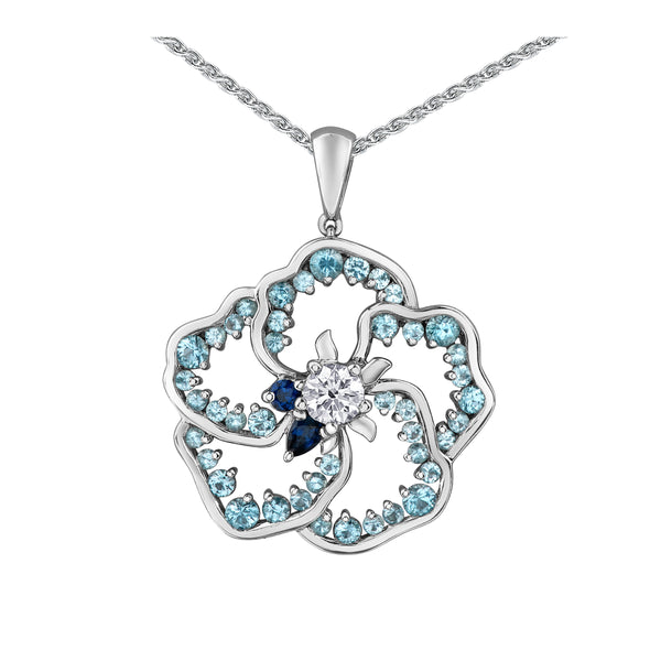 Crafted in 14K white Certified Canadian Gold, this pendant features a wildflower set with  blue topaz, blue sapphires and a round brilliant-cut Canadian centre diamond . 