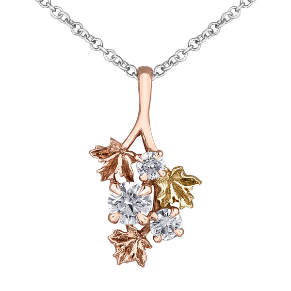 Crafted in 14KT rose and yellow Certified Canadian Gold, this necklace features a cluster pendant with three round brilliant-cut Canadian diamonds and three maple leafs.