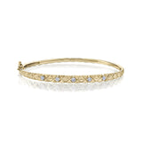 Crafted in 14KT yellow Certified Canadian Gold, this quilted bangle bracelet is set with five round brilliant-cut Canadian diamonds.