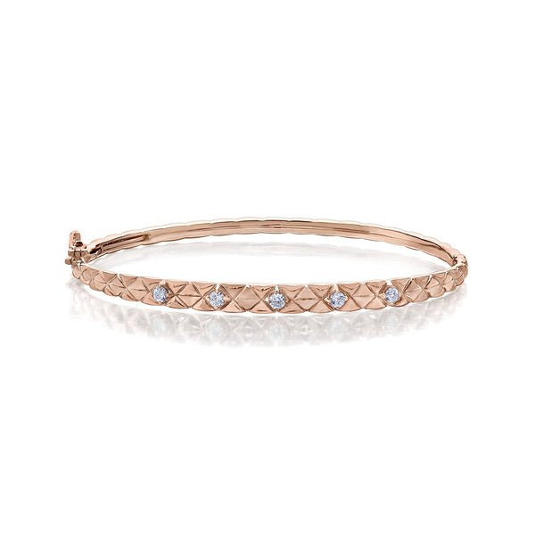 Crafted in 14KT rose Certified Canadian Gold, this quilted bangle bracelet is set with five round brilliant-cut Canadian diamonds.