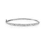 Crafted in 14KT white Certified Canadian Gold, this quilted bangle bracelet is set with five round brilliant-cut Canadian diamonds.