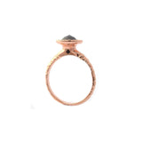 Crafted in 14KT rose gold, this ring features a diamond halo with a black rose-cut diamond centre and a quilted band. 
