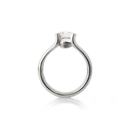 Crafted in 14KT white gold, this ring features a half-bezel set round brilliant-cut diamond with signature trademark on both sides. 