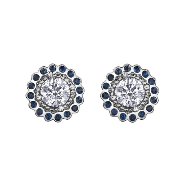 Crafted in 18KT white Canadian Certified Gold, these stud earrings feature regal blue sapphire halos with round brilliant-cut Canadian centre diamonds. 