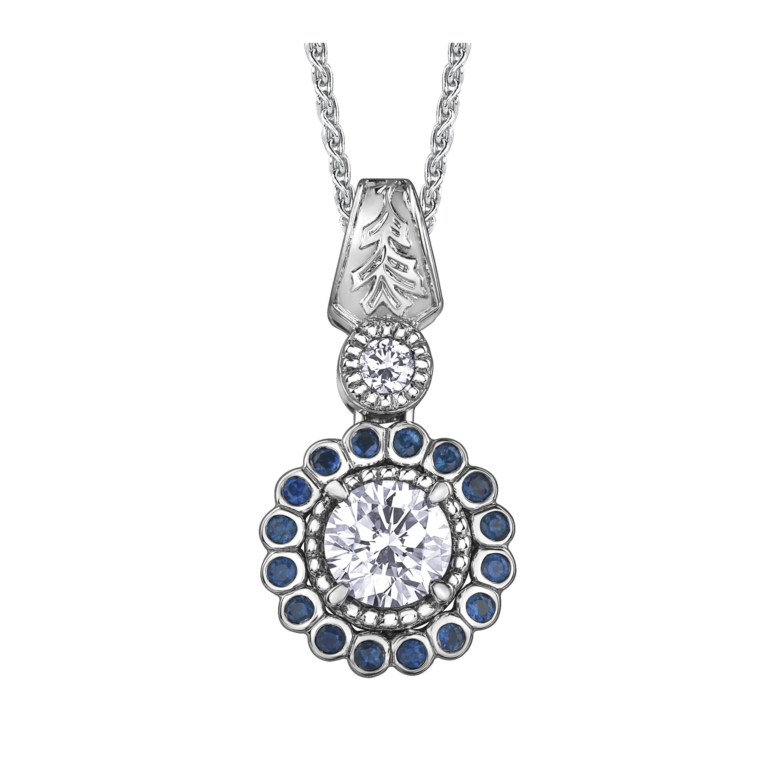 Crafted in 14KT white Canadian Certified Gold, this necklace features a regal blue sapphire halo with a round brilliant-cut Canadian centre diamond with a frost-inspired hand engraved bail. 