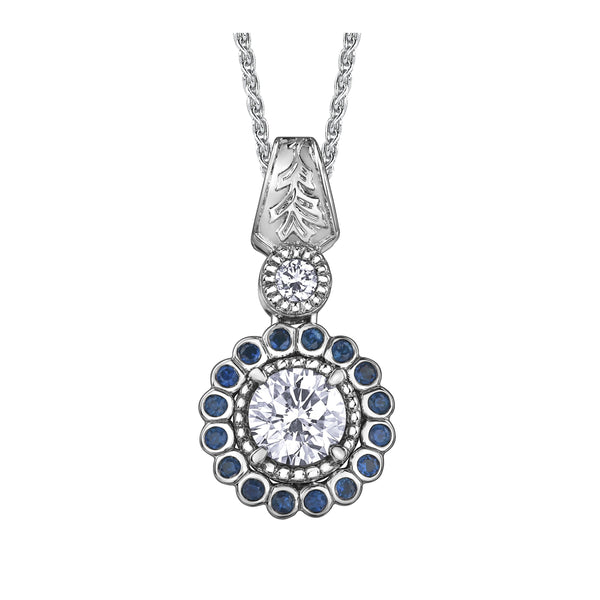 Crafted in 14KT white Canadian Certified Gold, this necklace features a regal blue sapphire halo with a round brilliant-cut Canadian centre diamond with a frost-inspired hand engraved bail. 