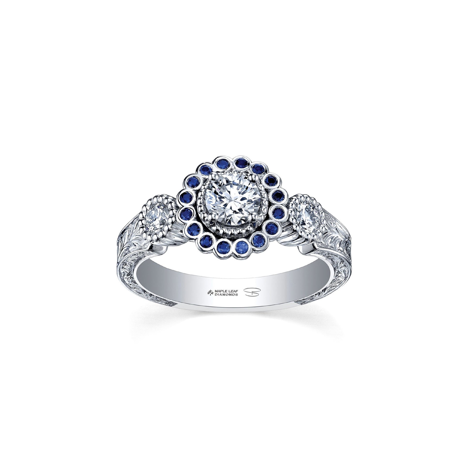 Crafted in 18KT white Canadian Certified Gold, this ring features a regal blue sapphire halo with a round brilliant-cut Canadian centre diamond on a frost-inspired hand engraved band. 