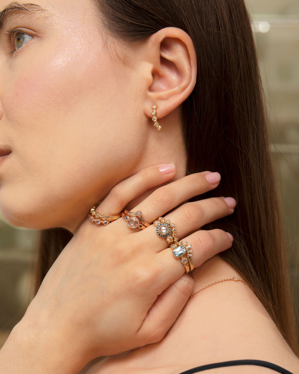 Close up of Vintage style rings paired together showing many options of wedding and engagement rings featuring diamonds, sapphire and aquamarine with hand-engraving in yellow white and rose gold.