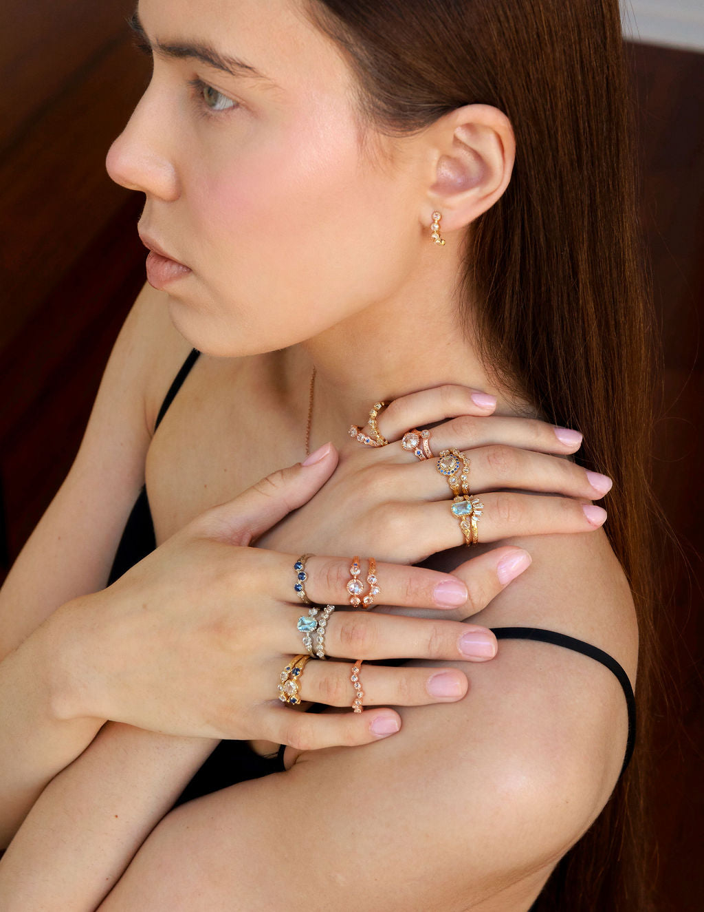 Vintage style rings together on hands showing many options of wedding and engagement rings featuring diamonds, sapphire and aquamarine with hand-engraving in yellow white and rose gold.