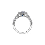 Crafted in 18kt Pure White™, this ring features an emerald-cut Canadian centre diamond framed by round and baguette-cut diamonds on a frost-inspired hand engraved band with a blue sapphire detail.