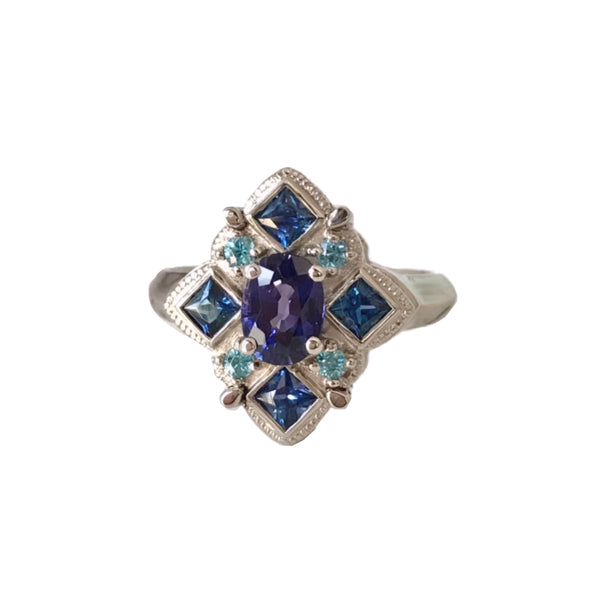 Crafted in 14KT white gold, this ring features round, oval and square colourful sapphires set in a diamond shape.