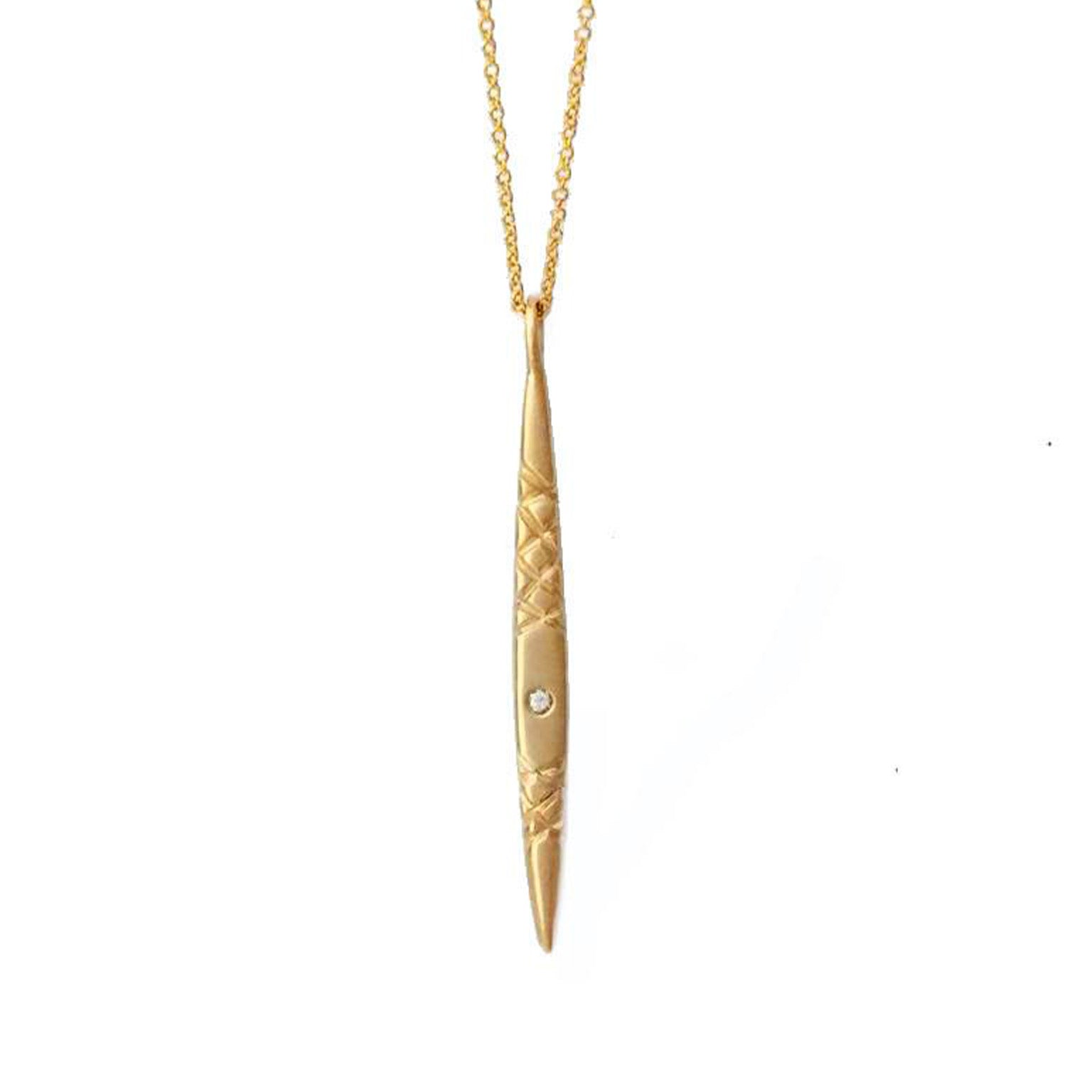 Crafted in 14KT yellow gold, this spear inspired pendant features a round white diamond and quilted details. 